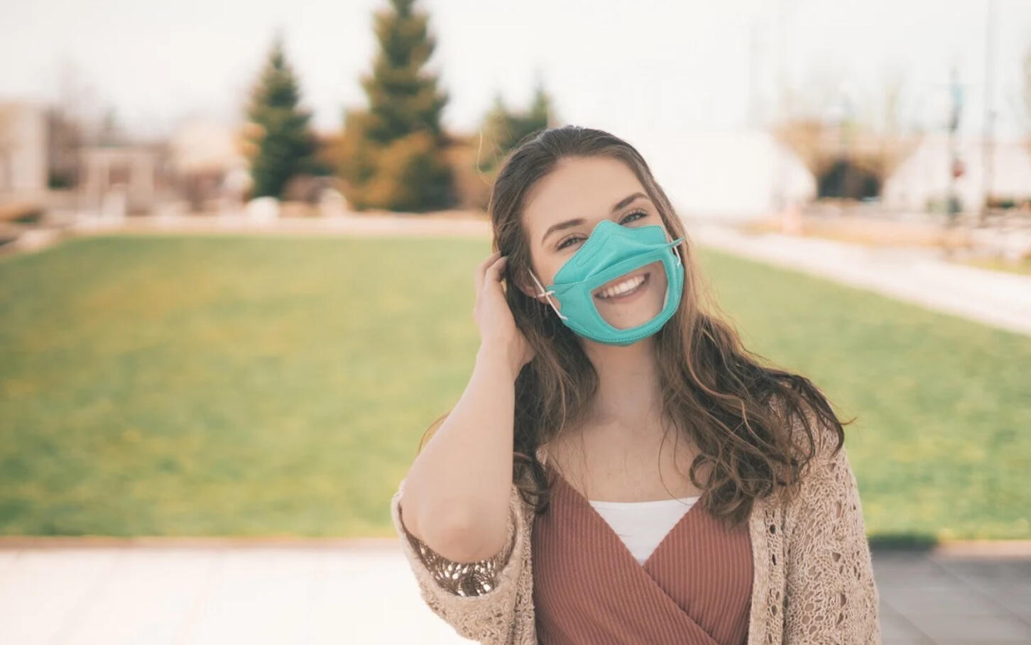 Woman in turquiose mask with clear window